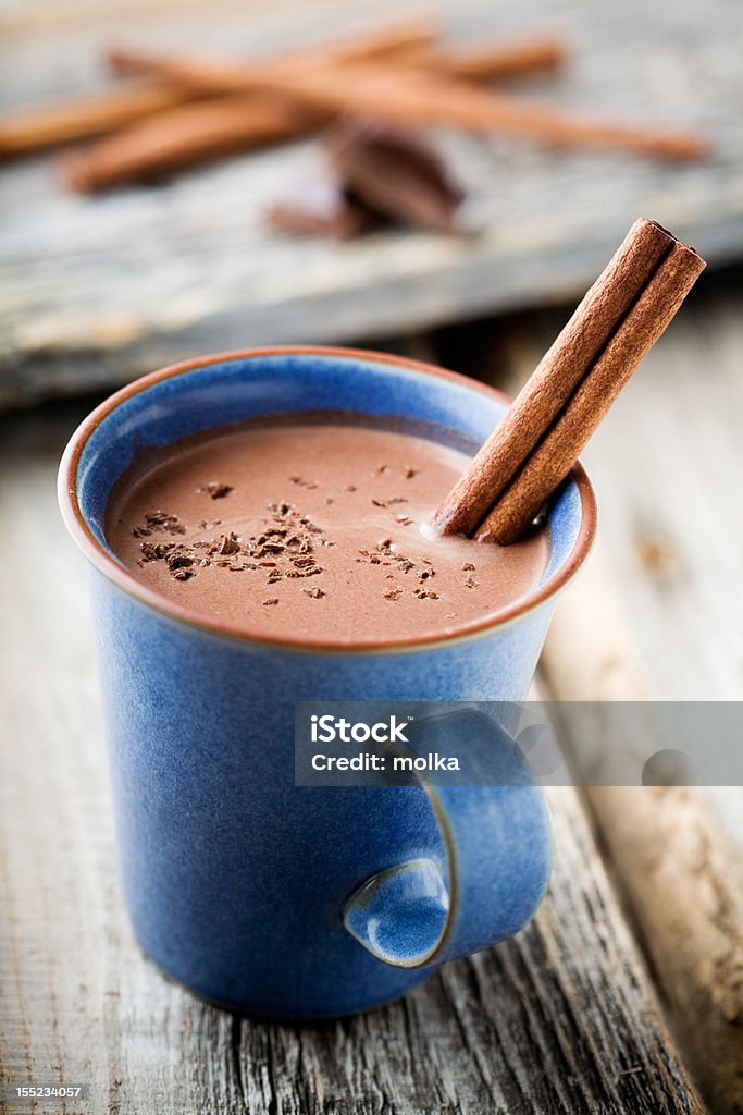 Hot chocolate Hot chocolate with cinnamon stick in blue cup Beige Stock Photo