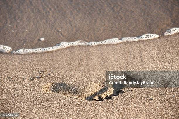 Wave Approaching Footprint In Sand Stock Photo - Download Image Now - Barefoot, Beach, Footprint