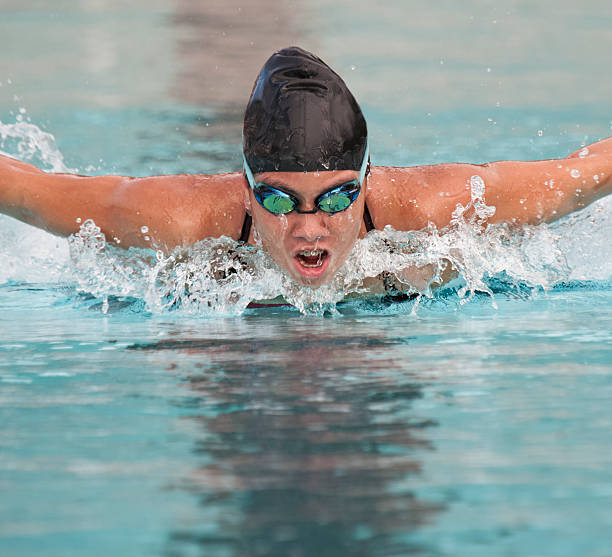 Competitive Female Athlete swimming Butterfly Sroke stock photo