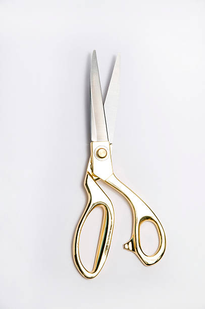 Goden Scissor The golden scissor on the white background gold scissors stock pictures, royalty-free photos & images