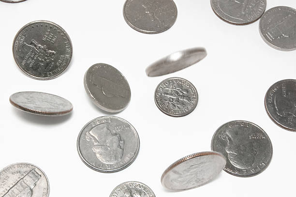 Falling US coins on isolated background Change falling on white background. Dimes and quarters. All in focus with slight motion blur ten cents stock pictures, royalty-free photos & images