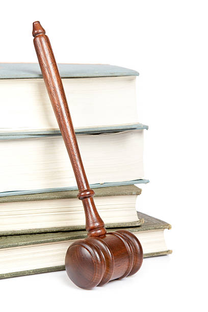 istock Wooden gavel leaning against a stack of books 155236314