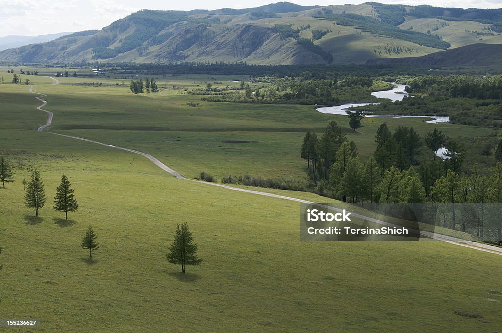 Jalman Meadows in Mongolia Typical Mongolian valley and winding river Dirt Road Stock Photo