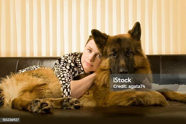 Woman And Her Dog Laying On A Sofa Stock Photo - Download Image Now - Adult, Adults Only, Animal