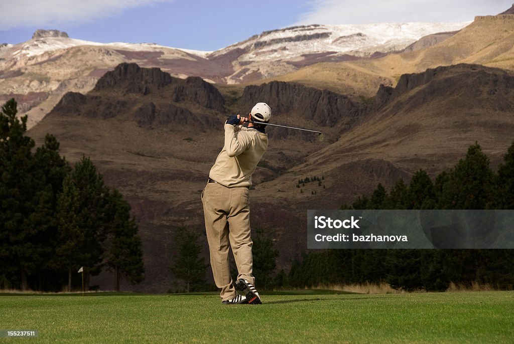 Golfer in the Andes Man playing golf on a beautiful golf course (Chapelco) in the Andes mountains in the Lake District of Argentina, near San Martin de los Andes   Golf Stock Photo