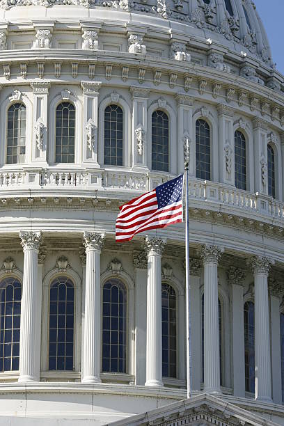 istock American Flag at The capitol building in Washington, DC. 155238590
