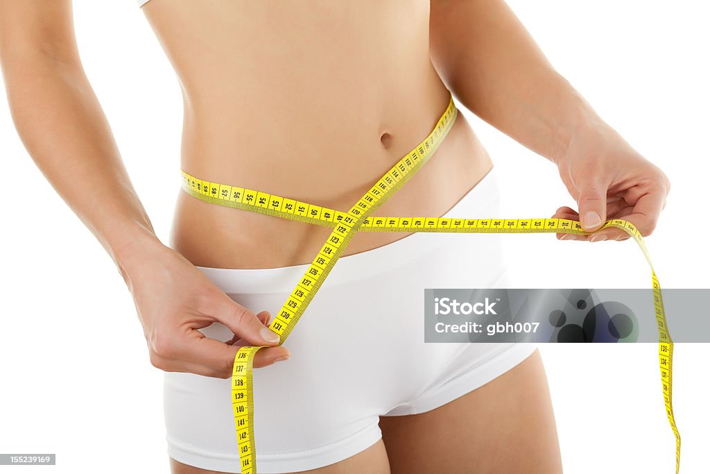 Slim body Woman measuring her body Abdomen Stock Photo