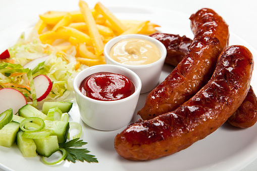 Grilled sausages with fries and vegetables 