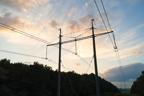 istock High voltage tower with electric power lines at sunset. 1552395382