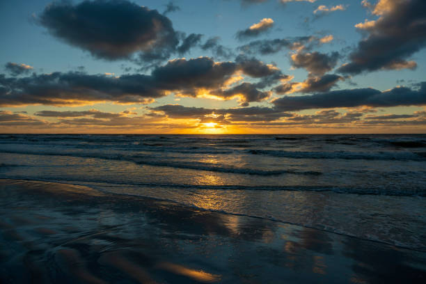 istock Ocean sunset landscape with soft evening sea water waves crushing on sandy beach 1552395434