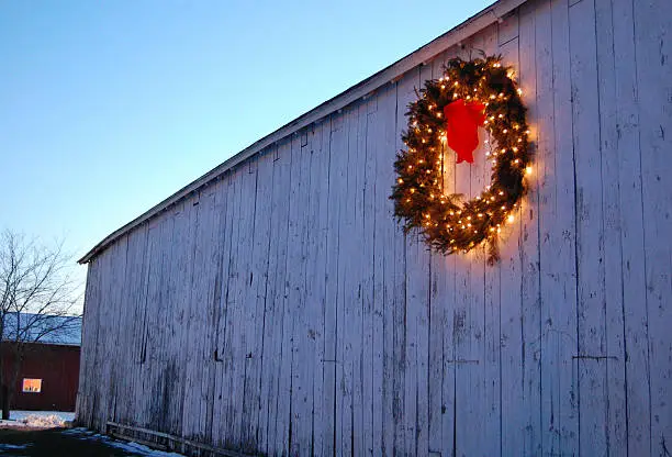 A Christmas wreath on the side of an old barn in a rural area of Connecticut