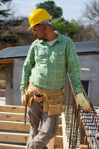 istock bricklayers with yellow helmet and protective glasses building an iron beam for reinforced concrete - PHOTO SESSION: WORK IN CONSTRUCTION 1552400581