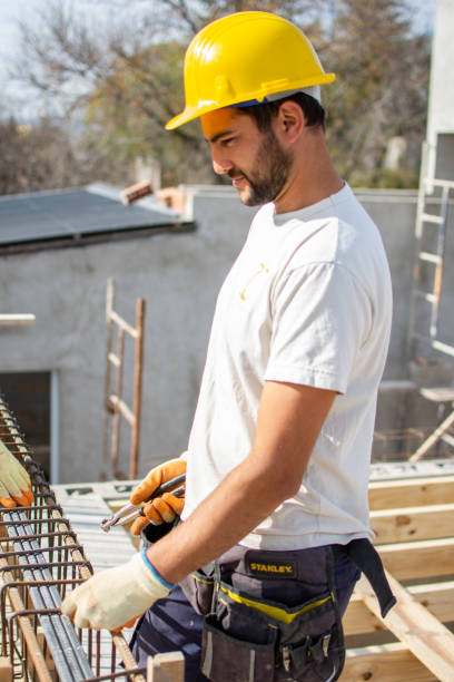 istock bricklayers with yellow helmet and protective glasses building an iron beam for reinforced concrete - PHOTO SESSION: WORK IN CONSTRUCTION 1552400626
