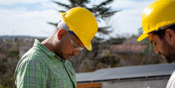 istock bricklayers with yellow helmet and protective glasses building an iron beam for reinforced concrete - PHOTO SESSION: WORK IN CONSTRUCTION 1552400762