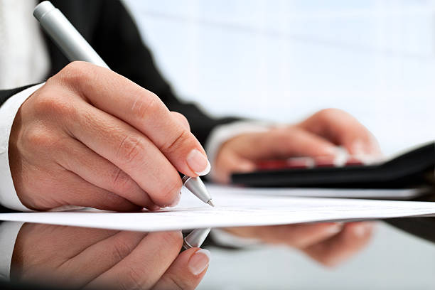 istock female hand wit pen pointing on paper 155240502