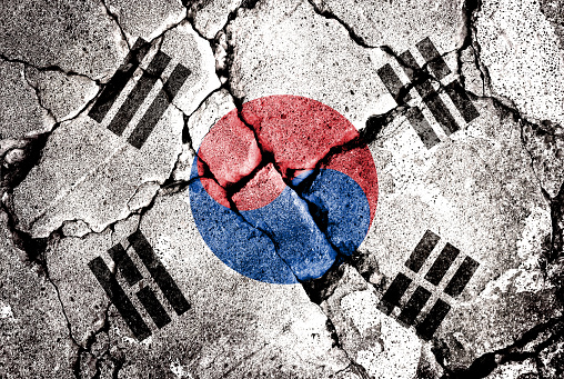 Double exposure of South Korea flag with cracks in gravel. A symbol of disintegration or division is depicted. Steps toward collapse. Useful for basemaps or report descriptions