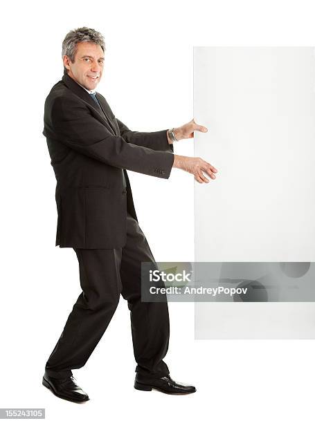 Confident Businessmen Pulling Empty Board Stock Photo - Download Image Now - Active Seniors, Adult, Adults Only