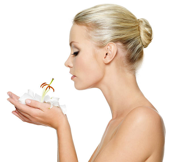 istock Beautiful young woman holding  a white lily at face 155243426
