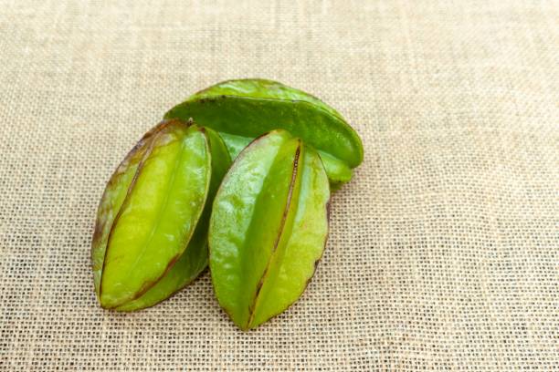 Carambola or Star Fruit Isolated on Burlap Background with Copy Space Carambola or Star Fruit Isolated on Burlap Background with Copy Space starfruit stock pictures, royalty-free photos & images