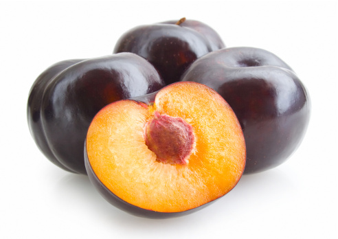 black plums isolated on white background