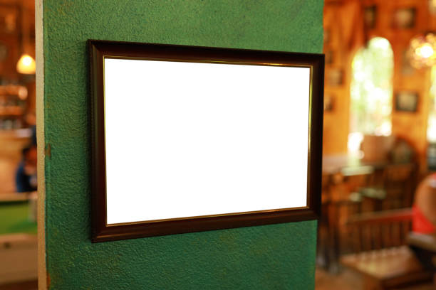 istock Mockup of picture frame decorated on wall. Empty blank white picture frame 1552444580