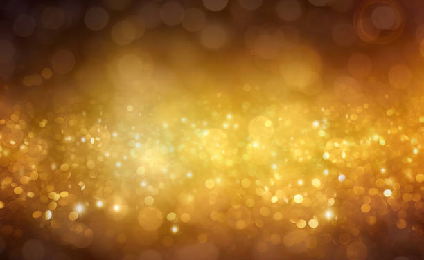 istock Gold glitters background. shimmering blur spot lights Bokeh Shiny gold light background texture 1552444782