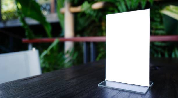 istock Mock up Menu frame standing on wood table in Bar restaurant cafe. space for text. 1552445352