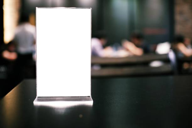 istock Menu frame standing on wood table in Bar restaurant cafe. space for text marketing promotion. 1552445354