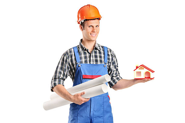 istock Male construction worker holding a model of house and blueprints 155244609