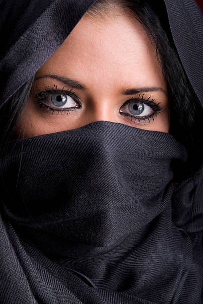 istock Arab woman with covered face in veil 155244654