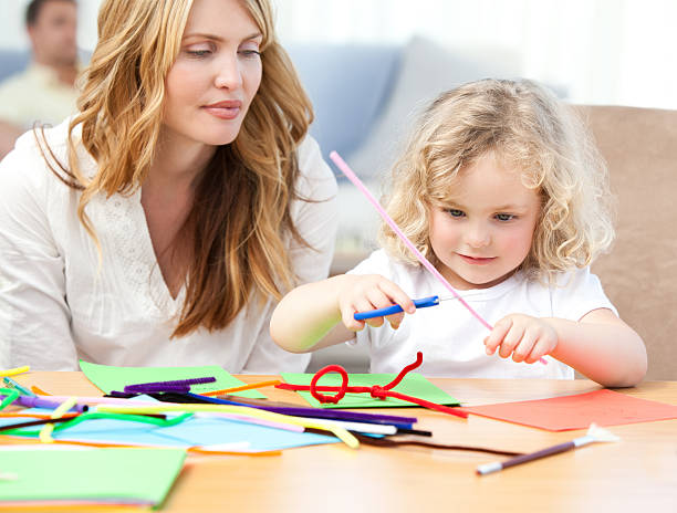 istock Woman and  her daughter cutting paper 155244836