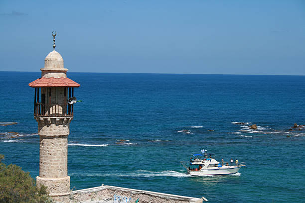 istock mosque minaret looking over a pleasure boat 155245098