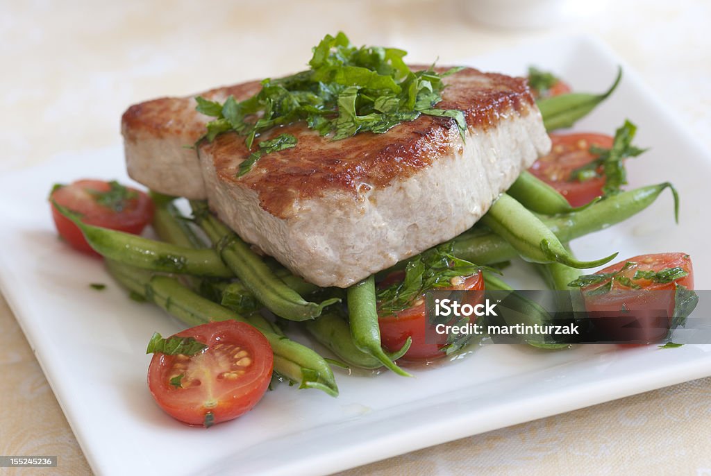 Close-up of grilled tuna steak on tomatoes and sword beans Char-grilled tuna steak with green beans and cherry tomatoes Tuna Steak Stock Photo