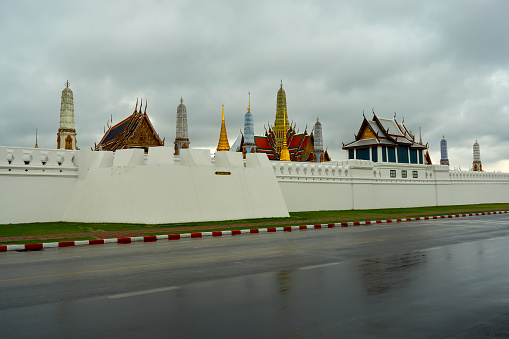 The landscape of the Grand Palace and the Temple of the Emerald Buddha in Bangkok on a cloudy day over this area is one of Thailand's most popular tourist attractions.