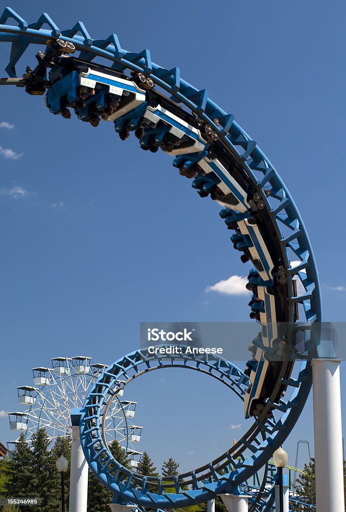 Cork-screw Rollercoaster Cork-screw Rollercoaster and Ferris-Wheel at amusement park. Slight motion blur on Rollercoaster cars Rollercoaster Stock Photo