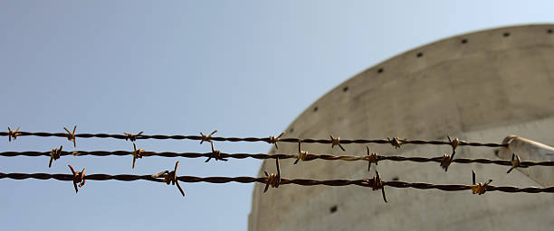 istock Horizontal barbed fence and concrete building 155247377
