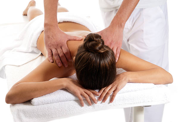 Unrecognizable woman receiving massage relax treatment close-up from male hands stock photo