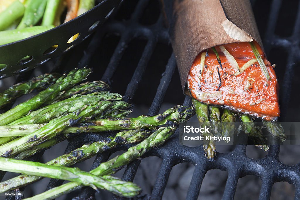 Cedar Wrapped Salmon and Asparagus on Grill Cedar wrapped salmon and asparagus on grill.  No flames. Asparagus Stock Photo