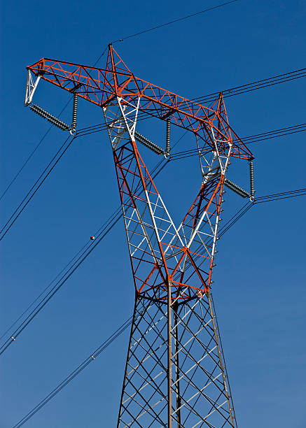 Electricity pylon Electricity red and white pylon against a blue sky. buzbuzzer energy cable steel cable stock pictures, royalty-free photos & images