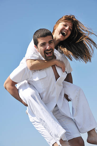 istock happy young couple have fun on beach 155248039