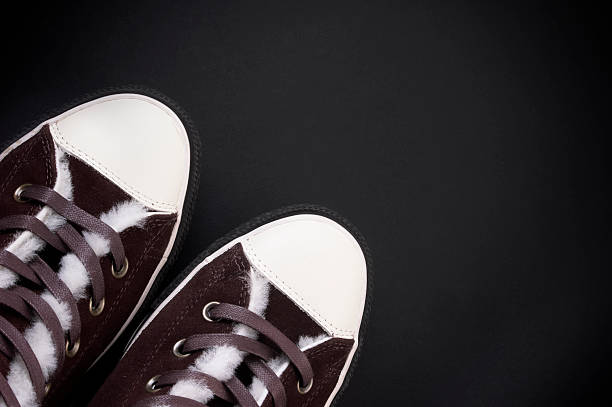 istock brown sneakers at black background 155249483
