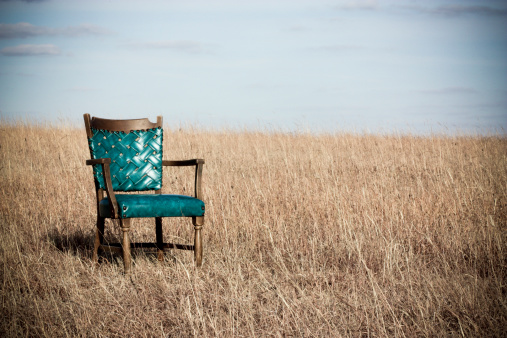 teal chair field sky blue yellow wheat clouds lounge seat arms dirt grass pasture