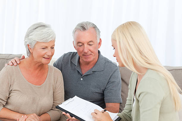 istock Seniors with doctor at home 155250817