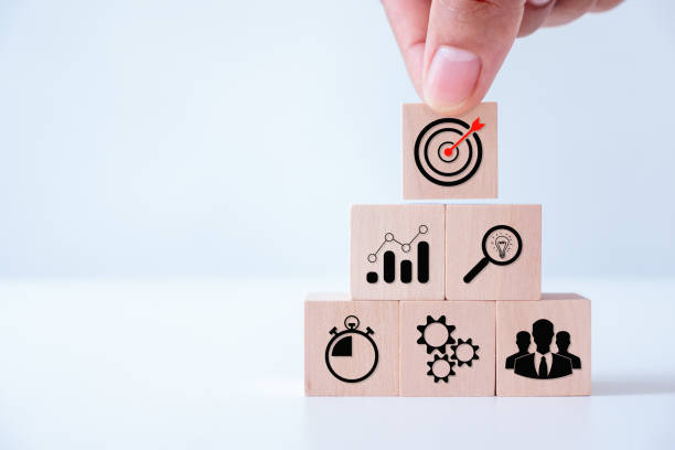 istock Goal and target, success and business target concept, hand stack woods block step on the table with icon Action plan,  project management, company strategy development. 1552514352