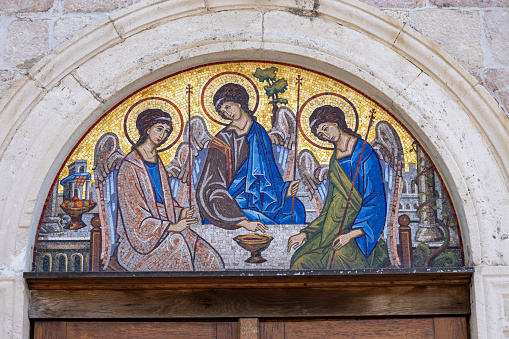 Budva, Montenegro - June 28, 2023: Religious themed mosaic above the entrance to the Holy Trinity Orthodox Church. The church is located in the Old Town, near the Citadel