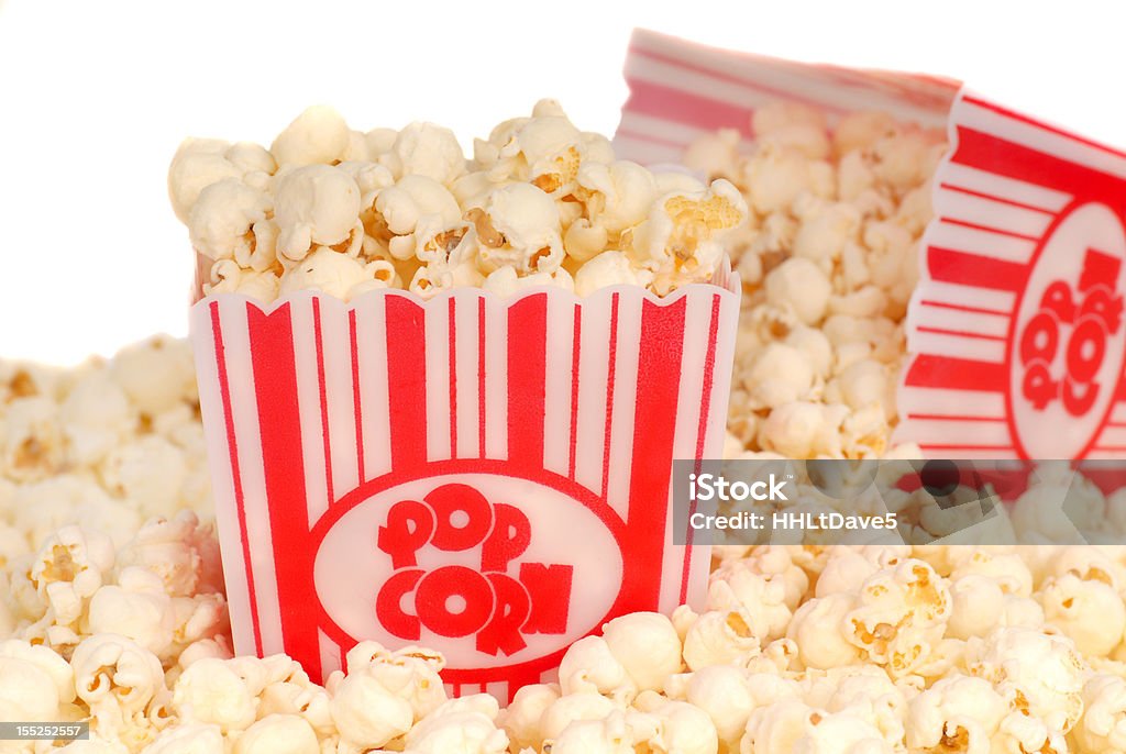 Two boxes of movie popcorn Two boxes of delicious movie popcorn with popcorn spilling out Concession Stand Stock Photo