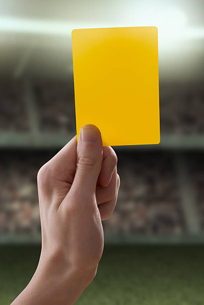 istock Yellow card with hand from referee giving a penalty 155253345