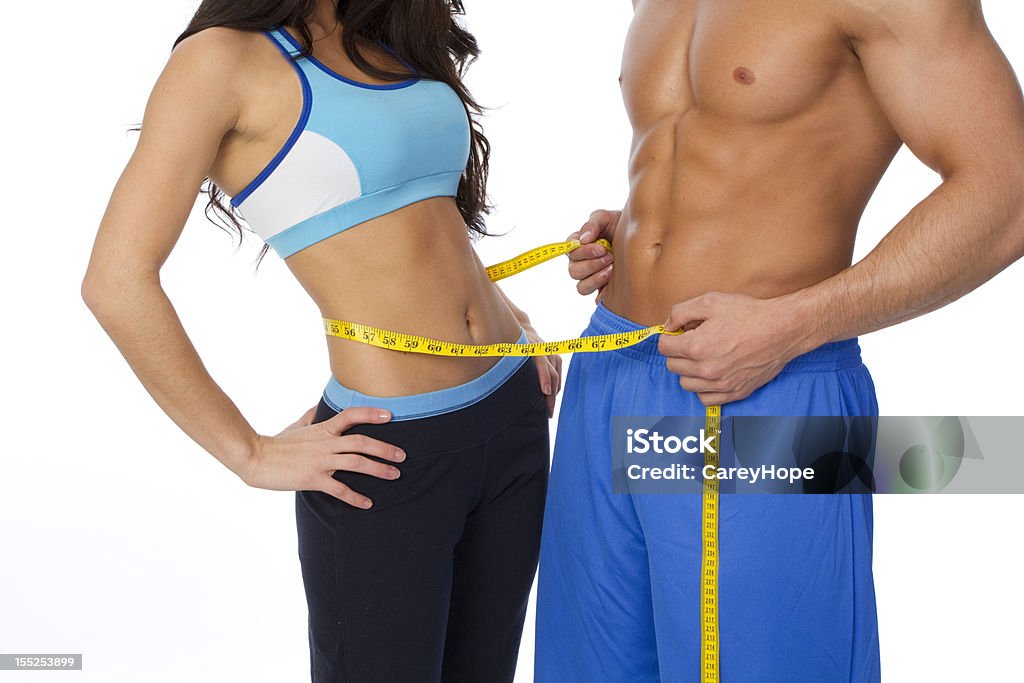 fit couple sexy fit couple showing weight loss, isolated on white background Abdomen Stock Photo
