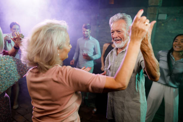 istock Happy mature couple dancing in a disco. 1552539734