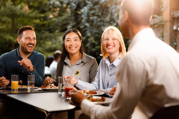istock Happy business colleagues talking on a lunch in a restaurant. 1552548330